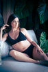 Pinnacle of Comfort and Style: Captivating Image of a Mother Relaxing in Luxuriously Soft Bamboo Maternity Lingerie.