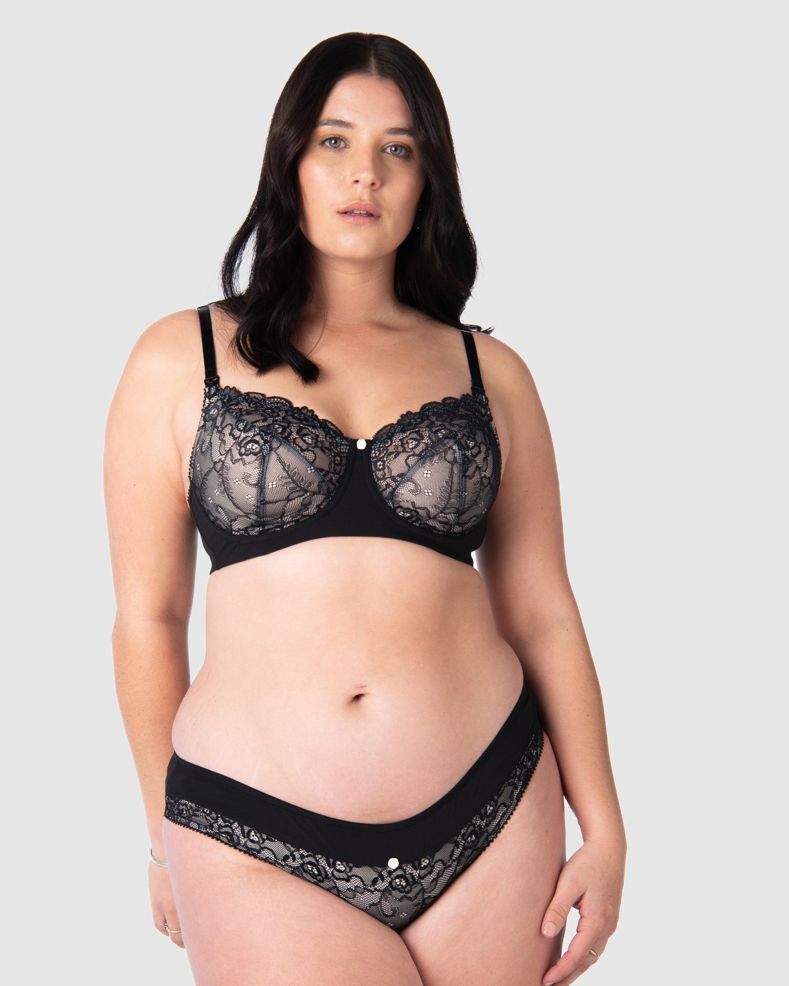 Olivia wears Hotmilk&#39;s award winning nursing and maternity set, featuring the Temptation Maternity Briefs that match the Temptation Flexiwire Nursing Bra. Sheer black lace over nude fabric, embodying delicate elegance in a coordinated maternity lingerie set, perfect for capturing the essence of maternity photoshoots